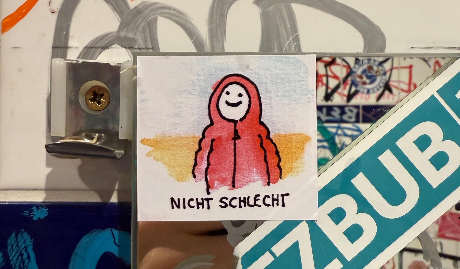 "Nicht schlecht" sticker on a bathroom mirror
